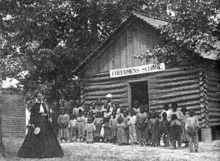 In front of a Freedmen’s schoolhouse (DiscoverFreedmen.org)